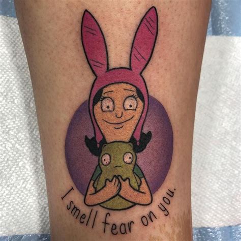I think one of the earliest, and easiest to miss, is in the credits of "Fort night". . Louise belcher tattoo
